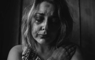grayscale photo of woman crying